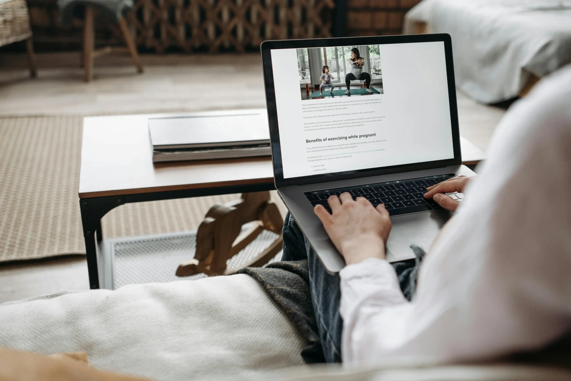Person researching content on a laptop to analyze wants vs needs in marketing from a consumer perspective.
