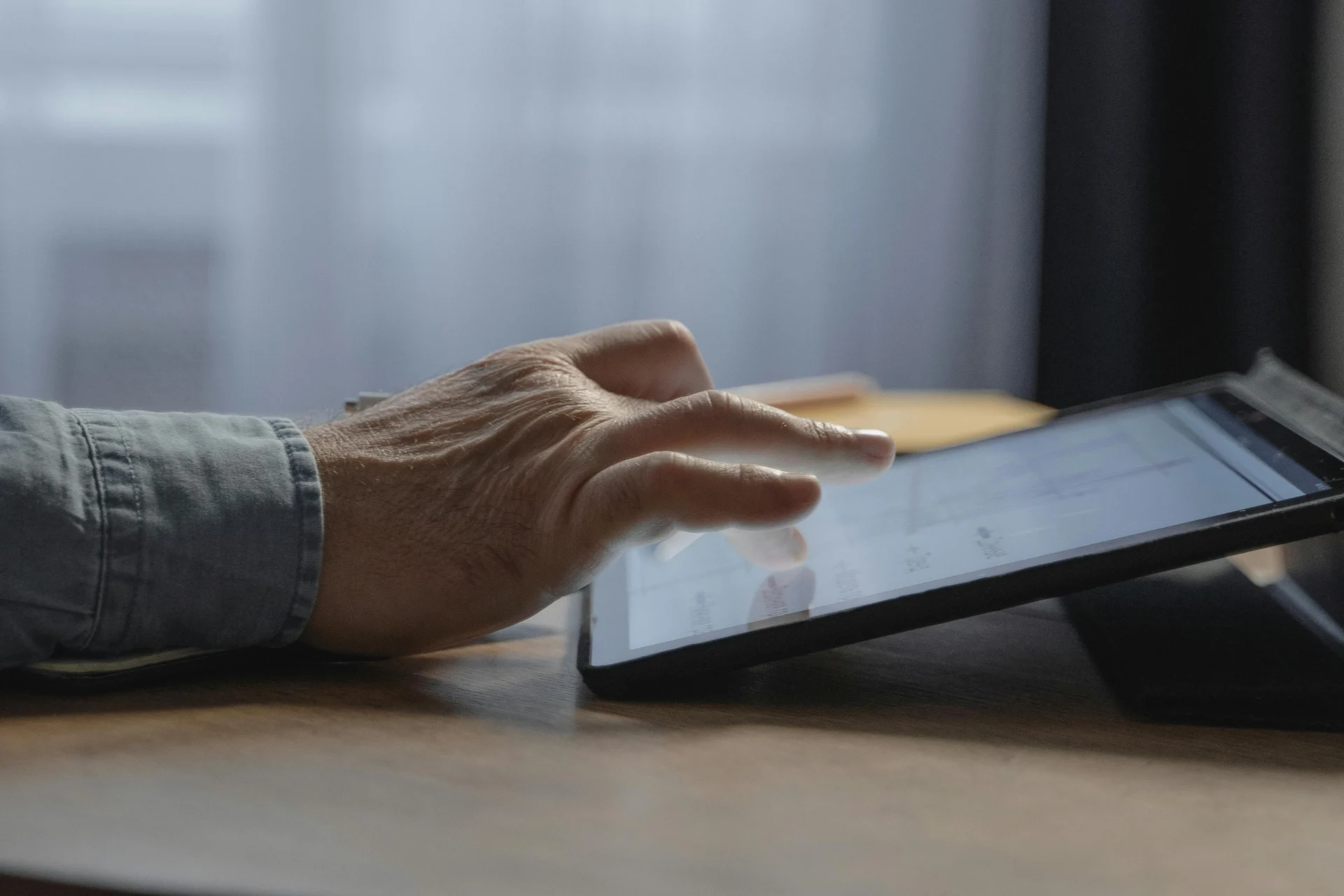 Close-up of a person's hands typing on a laptop keyboard while developing content for social media for businesses.