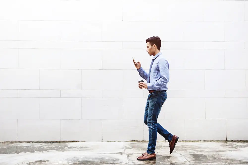 man texting while walking