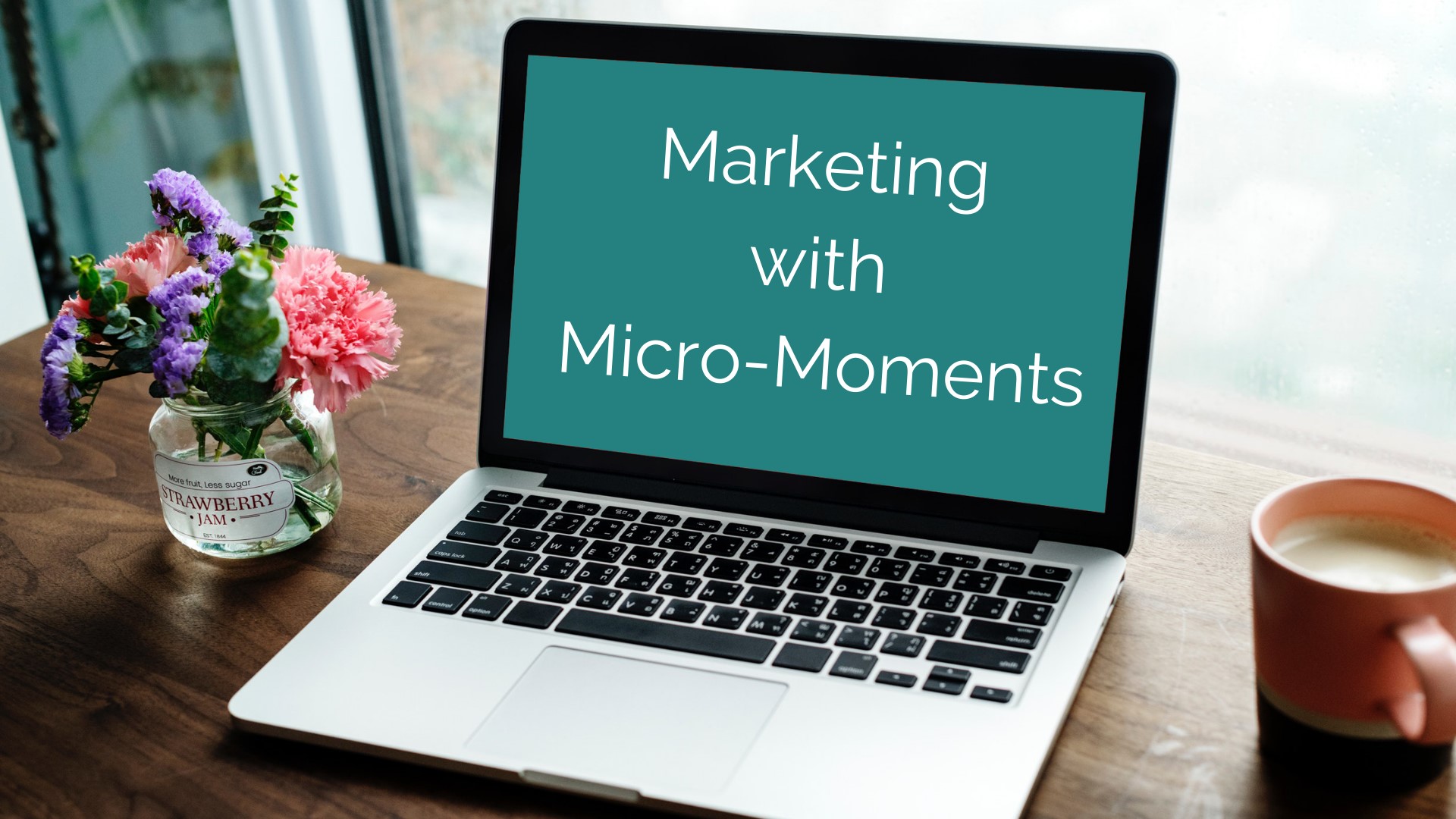 Photo of a laptop with a screen stating “marketing with micro-moments”