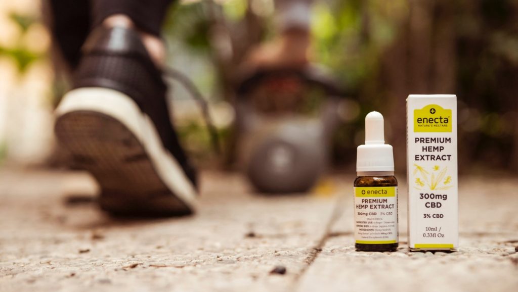Premium hemp extract bottle and packaging placed on a sidewalk for a cannabis influencers post