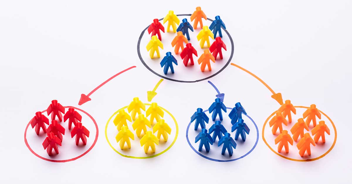 Dividing a group of colorful people icons into market segmentations.