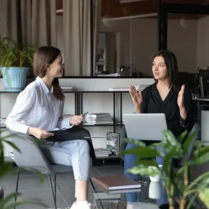 two women discussing marketing strategy