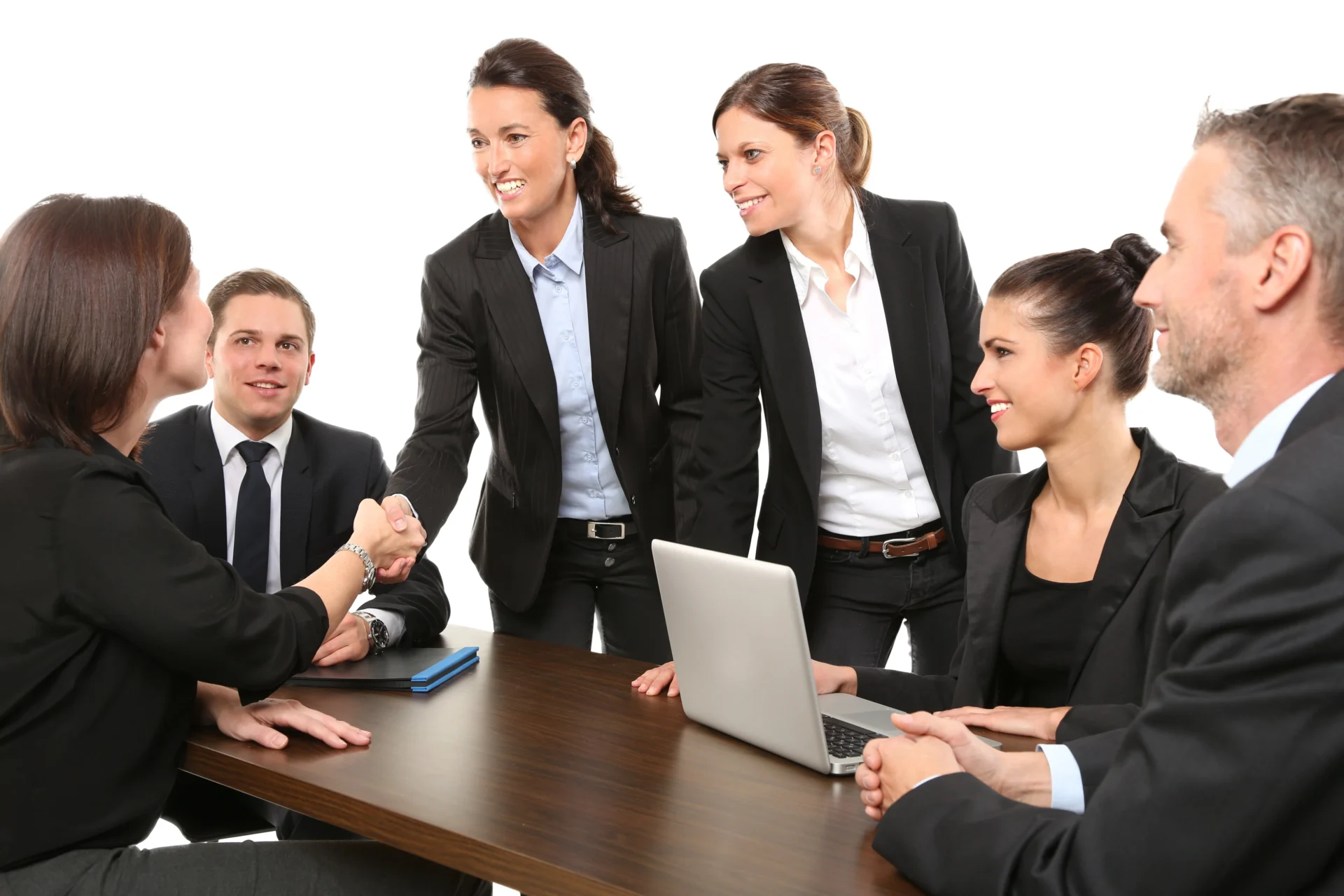 Business professionals shaking hands during a meeting, representing successful B2B marketing strategies