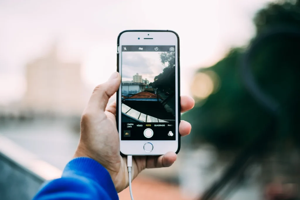 Man holding his phone taking a photo for CPG content creation