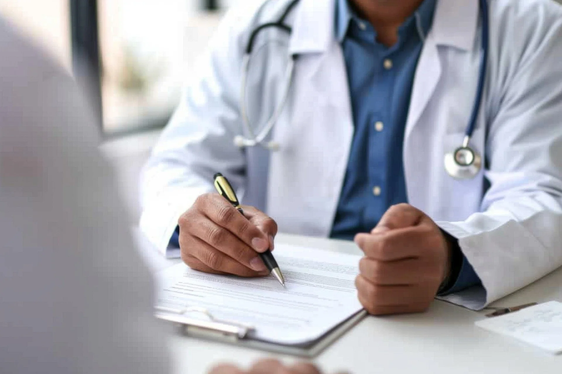 Doctor writing prescription for patient in B2B healthcare marketing.