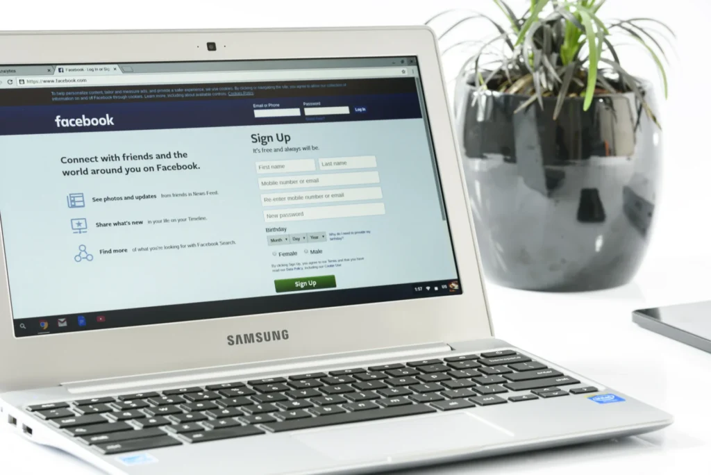 Laptop screen showing Facebook interface for Facebook Ads account log in