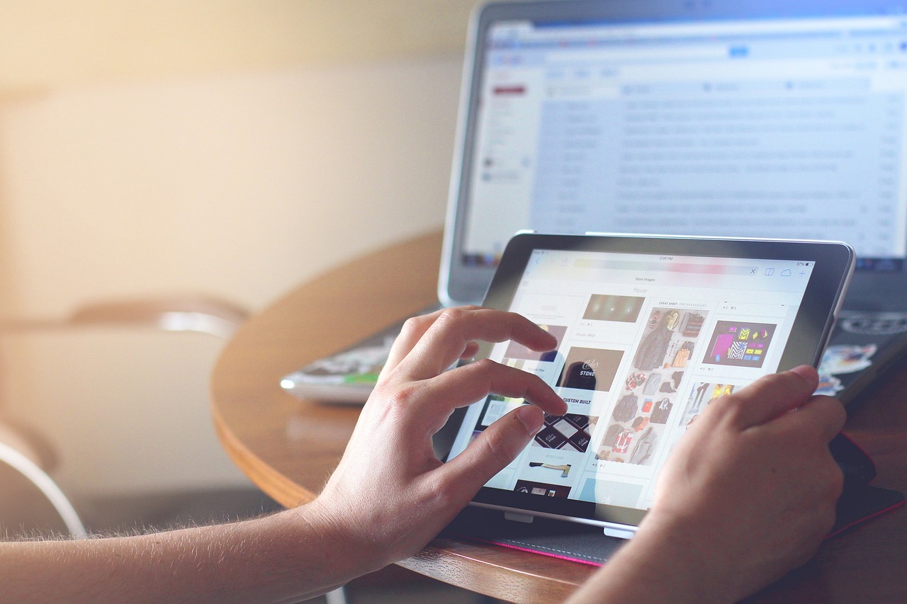 Person using a tablet to browse a website, demonstrating the importance of technical SEO for a smooth user experience.