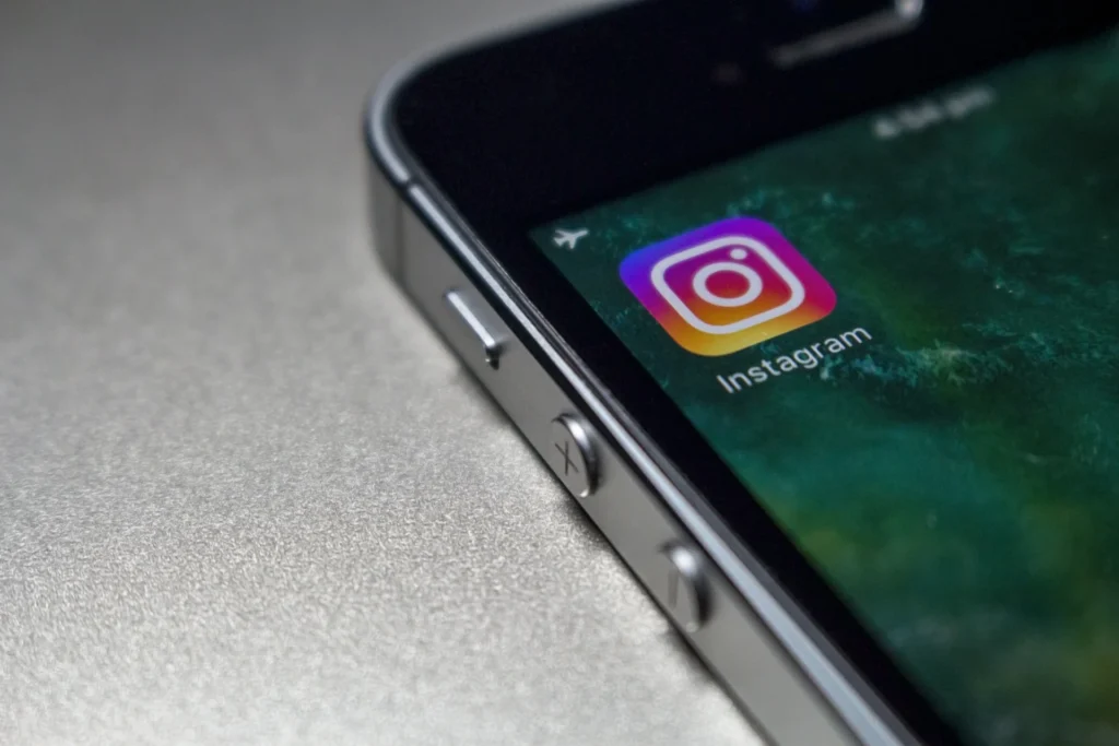 Smartphone displaying Instagram app icon, representing social media marketing