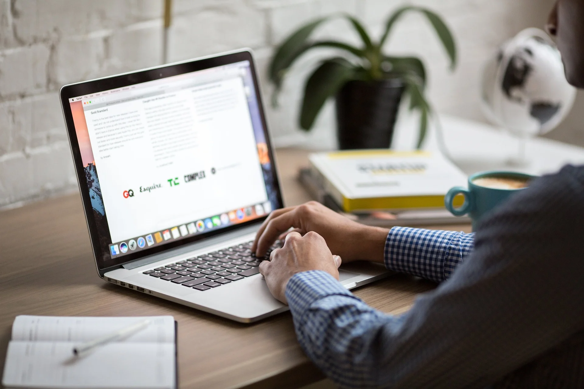 Person using a laptop to conduct keyword research for SEO optimization.