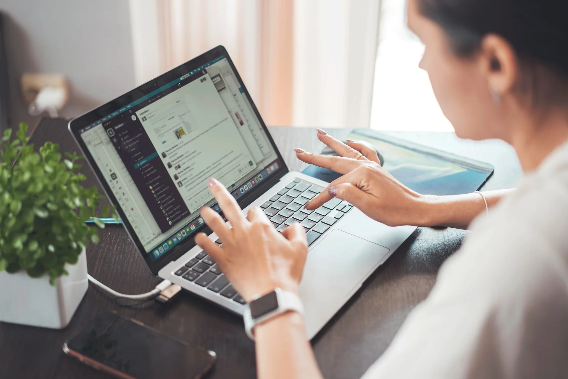 Woman working on laptop, composing email.