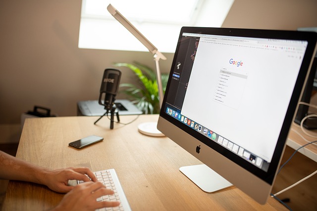 A person typing on a keyboard with a computer screen showing the Google search engine. This image represents the use of digital marketing tools for B2B businesses.