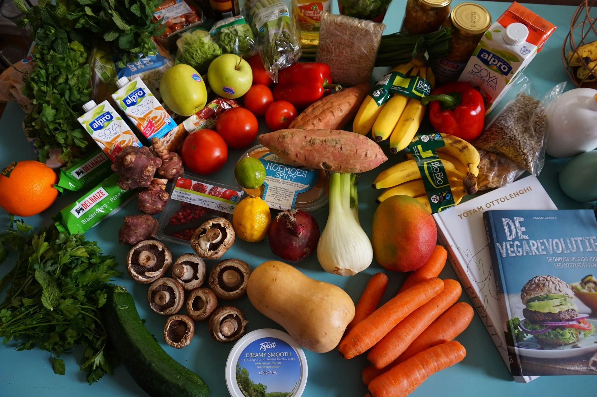 Diverse selection of fresh produce and packaged goods on a blue table, representing the growing CPG market.