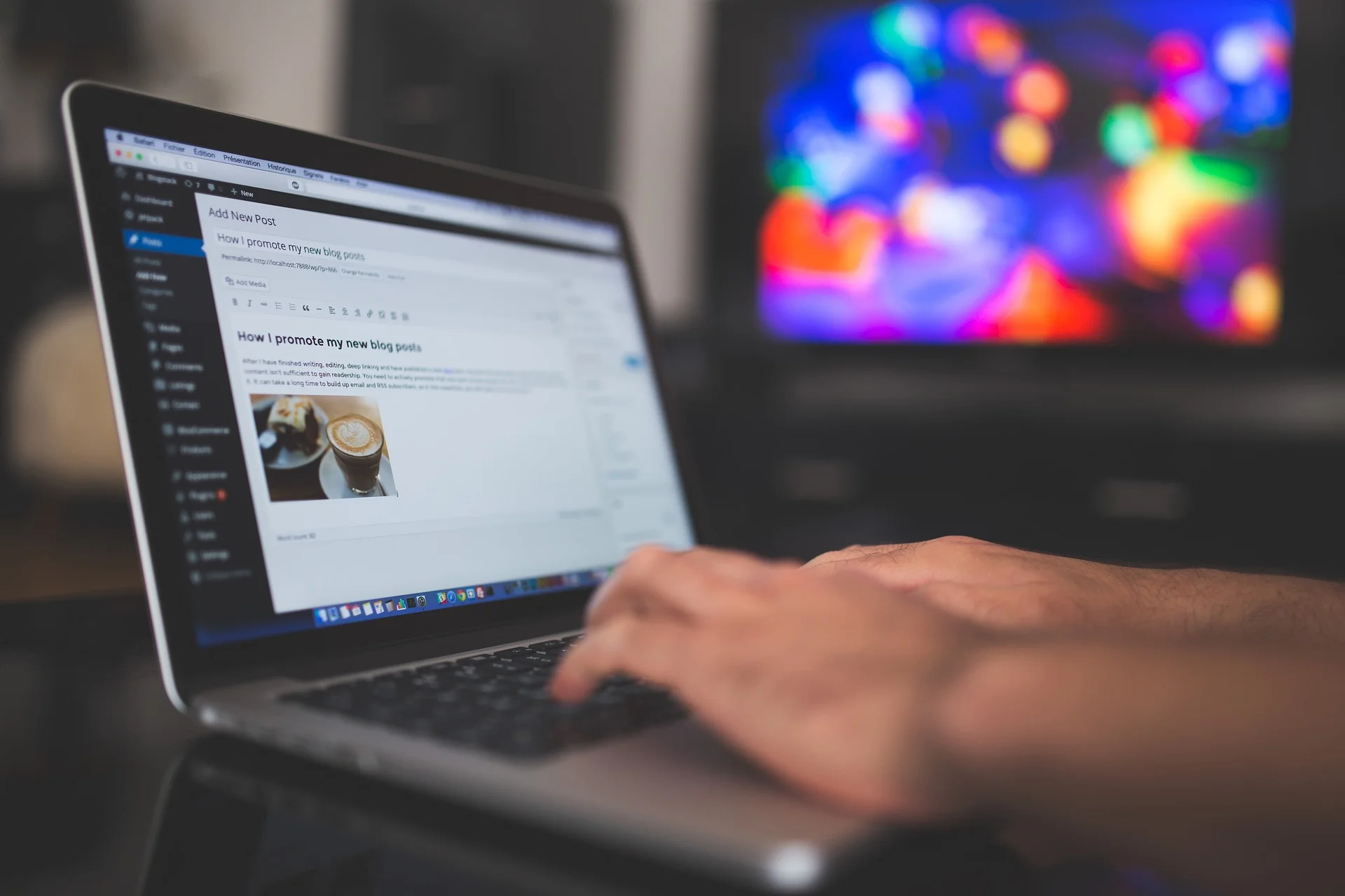 Person typing on a laptop with a blog post about B2B influencer marketing visible on the screen.