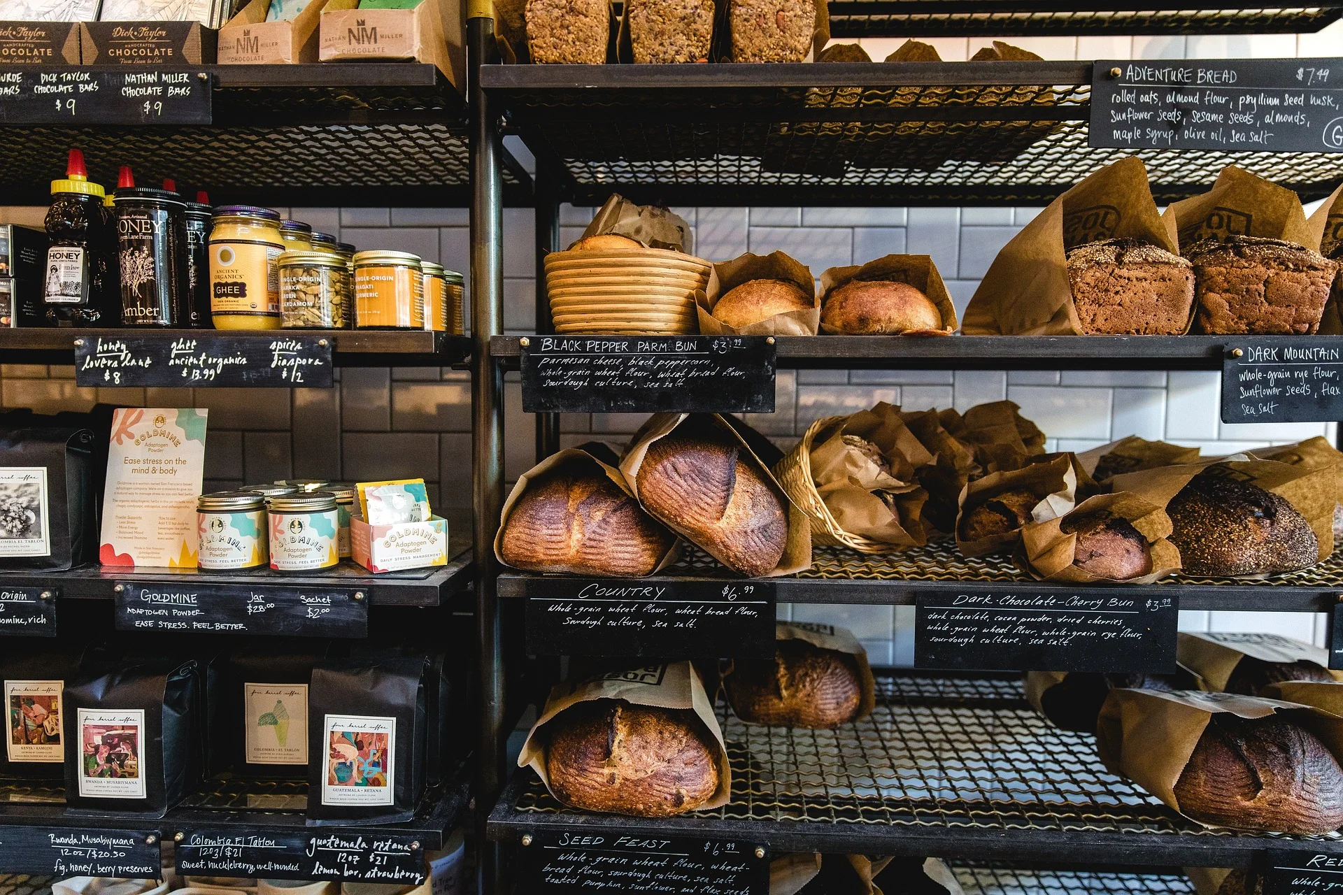 Assortment of artisan breads and baked goods on display at a bakery.