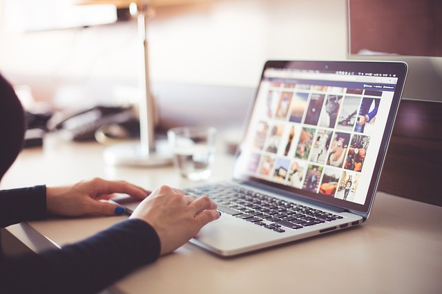 Digital marketing professional using a laptop for online tasks.