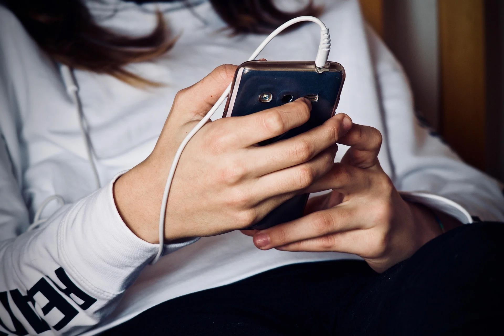 Person holding a smartphone while engaging with Reddit, illustrating effective strategies for how to market on Reddit.