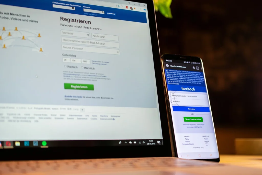 Laptop and phone displaying the Facebook app, focusing on a Facebook business page.