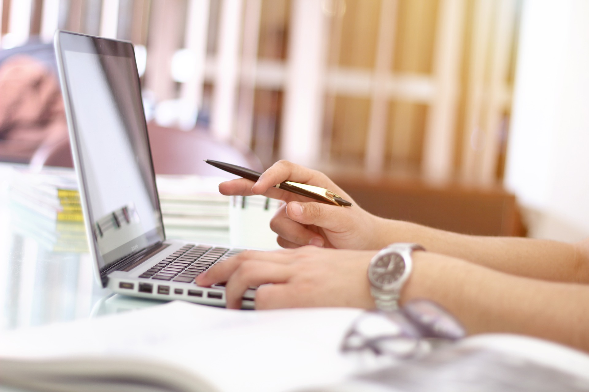 A person working on a laptop, researching White Hat Link Building Strategies.