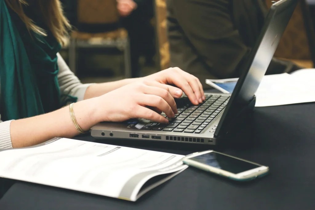 Person using a laptop while working, focusing on on-page SEO factors.