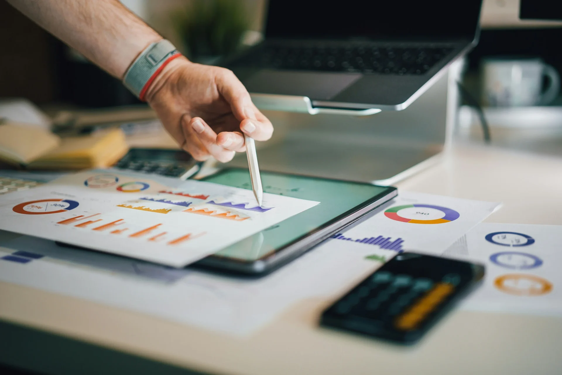 Businessperson working on a tablet, analyzing social media analytics charts.