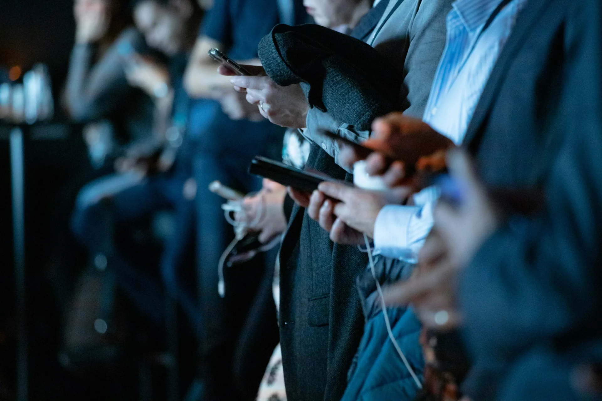 People using smartphones in a group, illustrating the need for social media marketing metrics to track engagement.