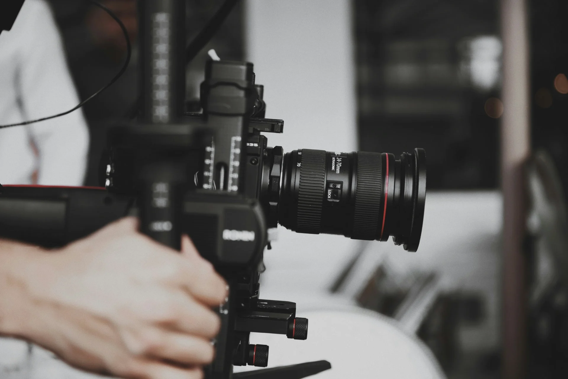 Videographer holding a camera, ready to create video content.