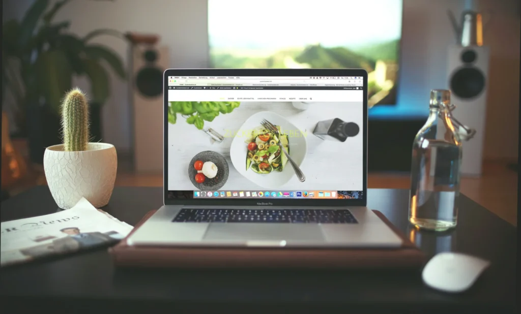 Laptop screen displaying a food-related website, illustrating social media marketing for food brands with visually appealing content.