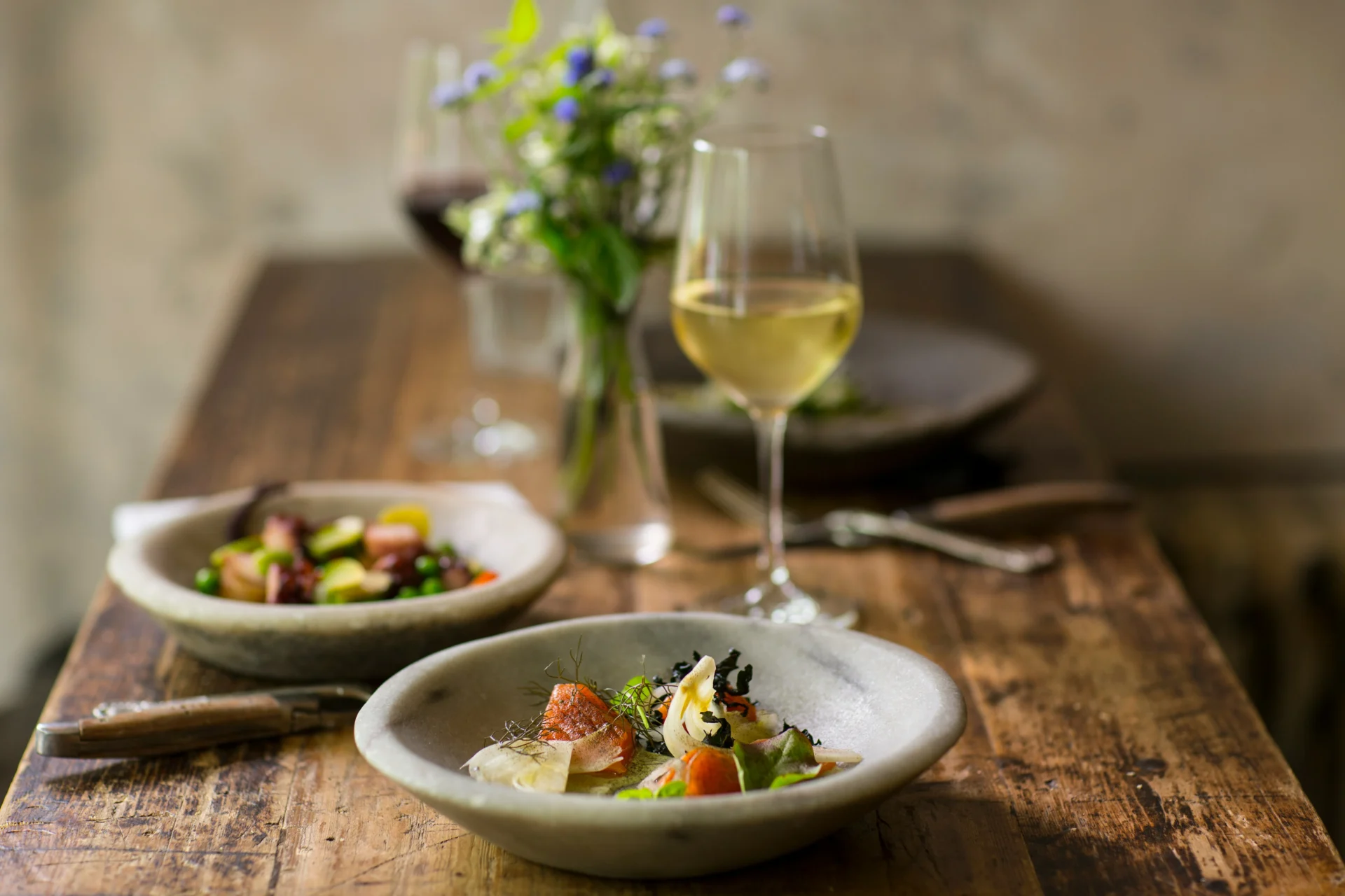 Stylized food and drink on a rustic table, representing food and drink advertising.