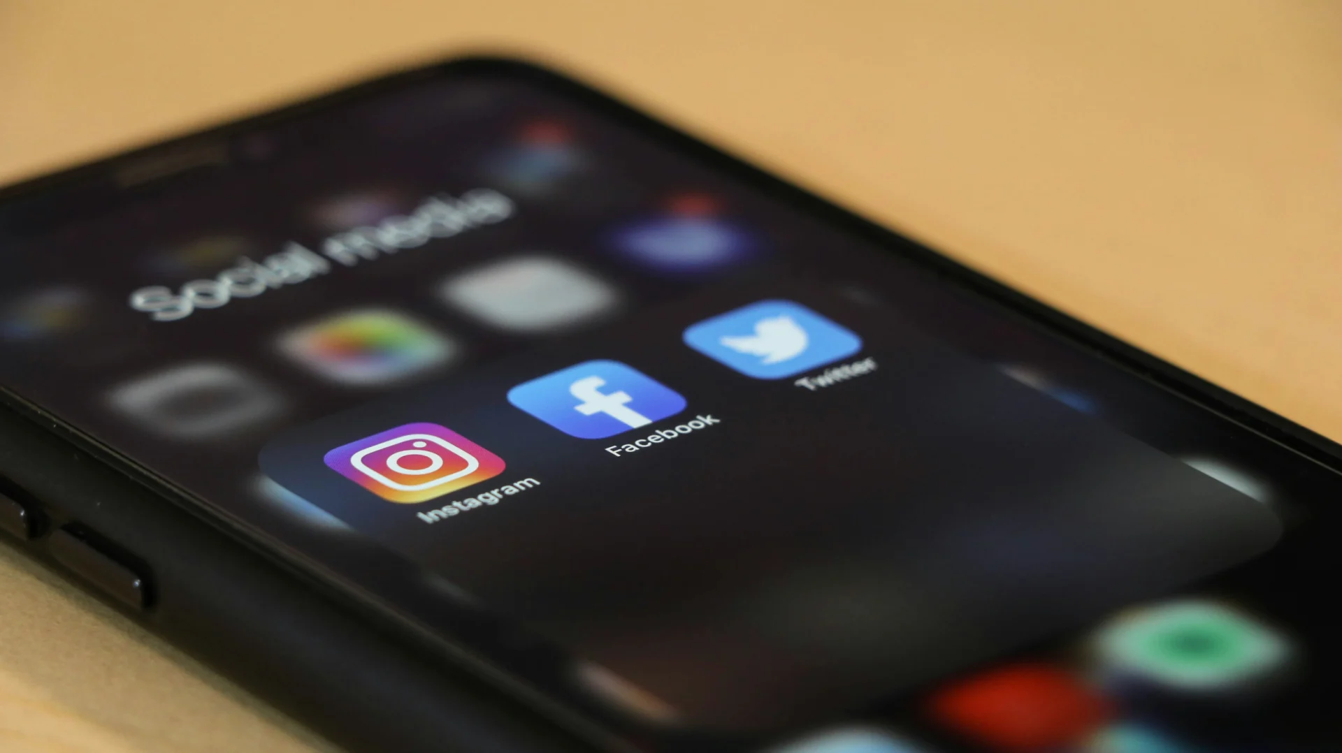 Smartphone screen showing Instagram and Facebook app icons, relevant to Facebook ads vs Instagram ads.