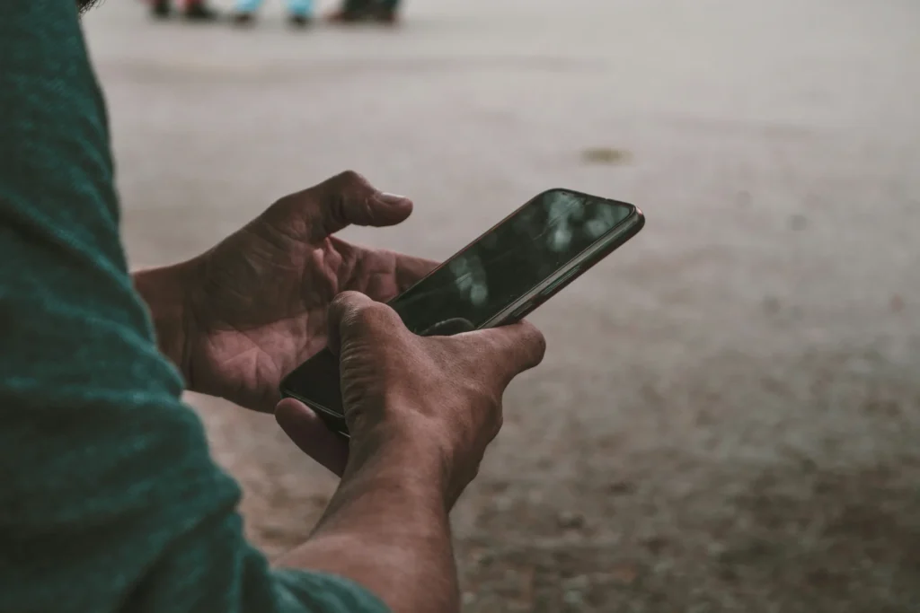 Hands holding a smartphone, representing the impact of mobile app marketing.