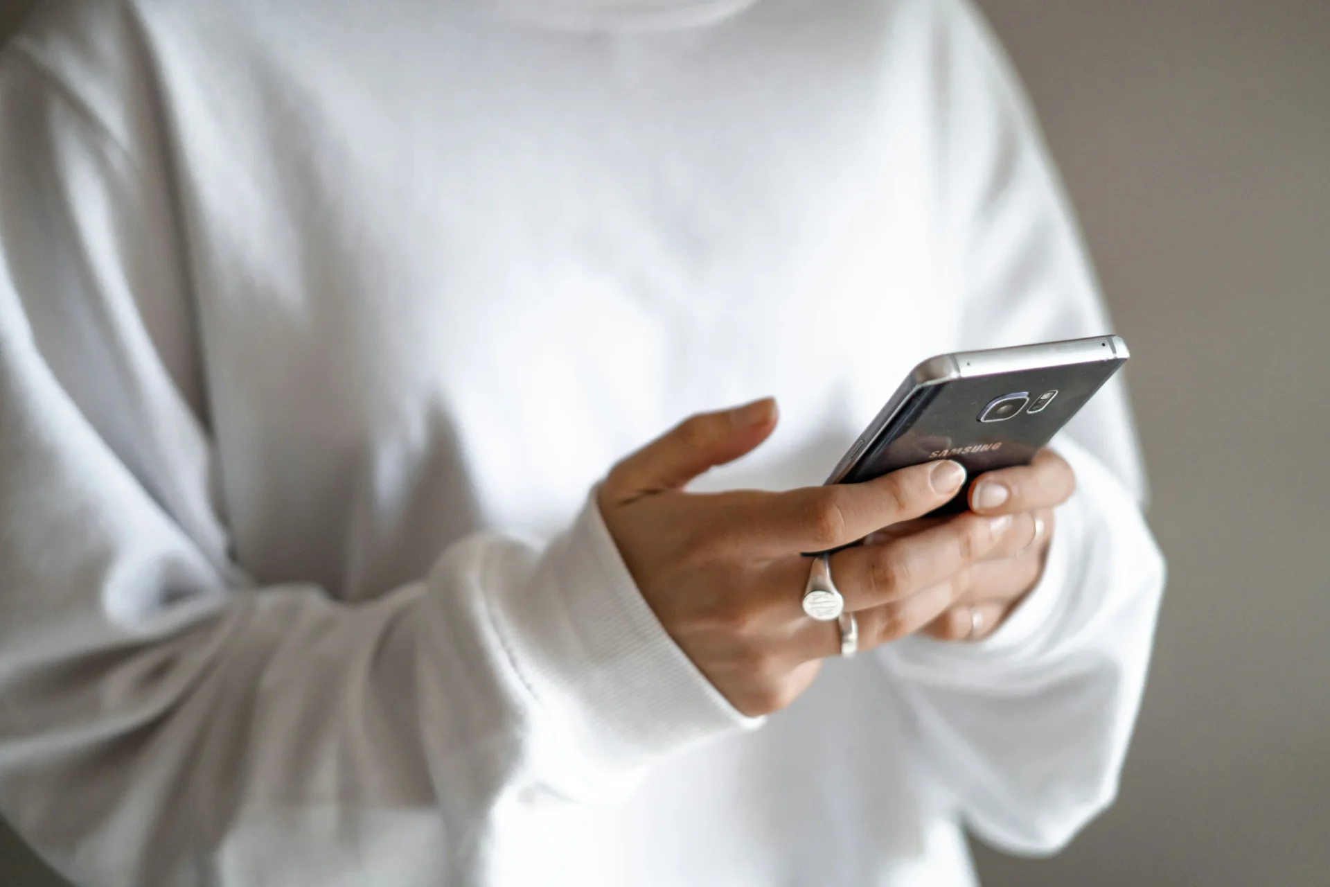 Woman interacting with smartphone, showcasing mobile app marketing strategies.