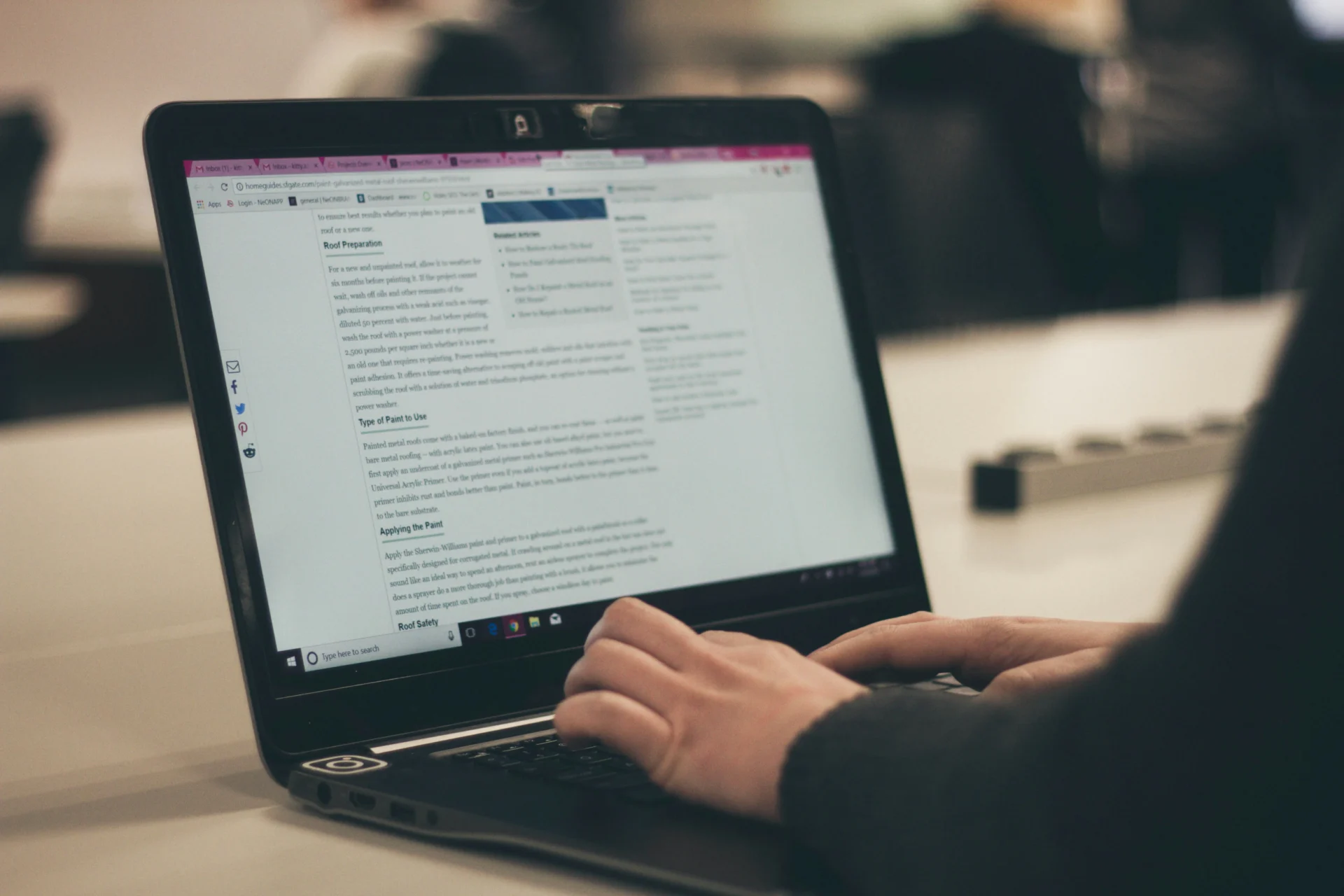 Hands typing on a laptop displaying a webpage with text, possibly related to a CEO's guide to content marketing.