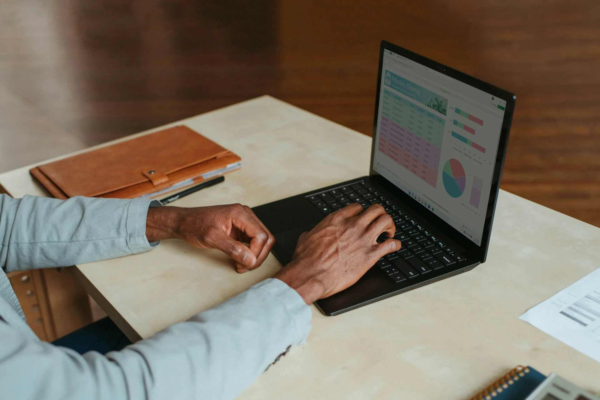 Hands typing on a laptop displaying data charts, emphasizing why local SEO matters for business analysis.