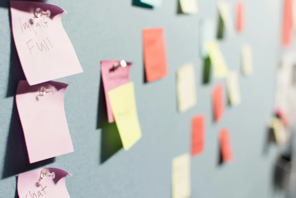 Close-up of a wall covered in colorful sticky notes with ideas, representing brainstorming for B2B search engine marketing strategies.