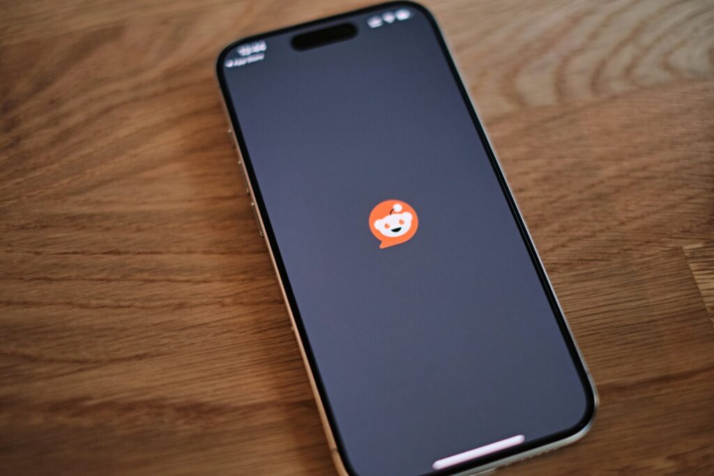 iPhone displaying the Reddit app loading screen with the Reddit logo, illustrating how to use Reddit for marketing.