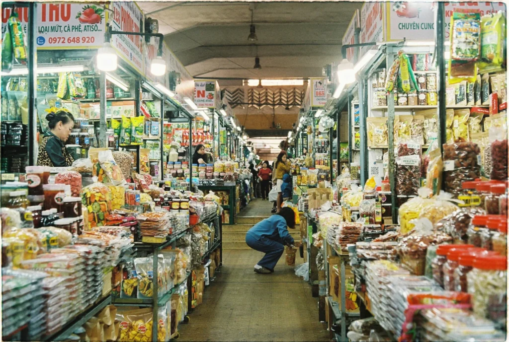 Shoppers navigate a busy market aisle filled with numerous products, providing a real-world setting to gather CPG consumer insights.