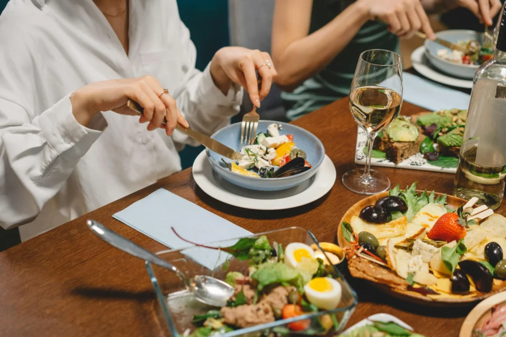 Friends enjoying a seafood meal together, a lifestyle image suitable for celebrity food advertisements.