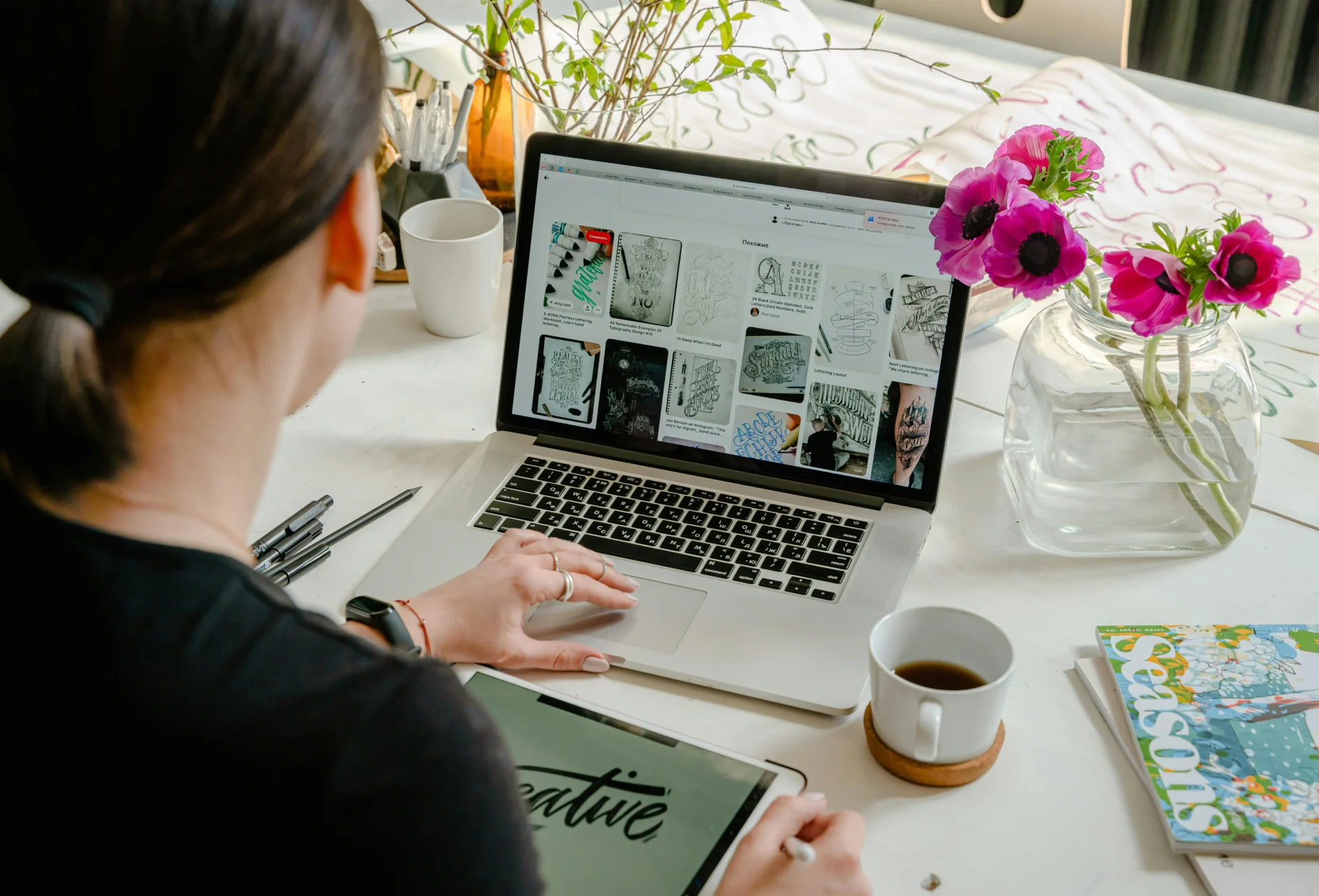 Woman analyzing financial charts and data on papers and a laptop to create content that converts.