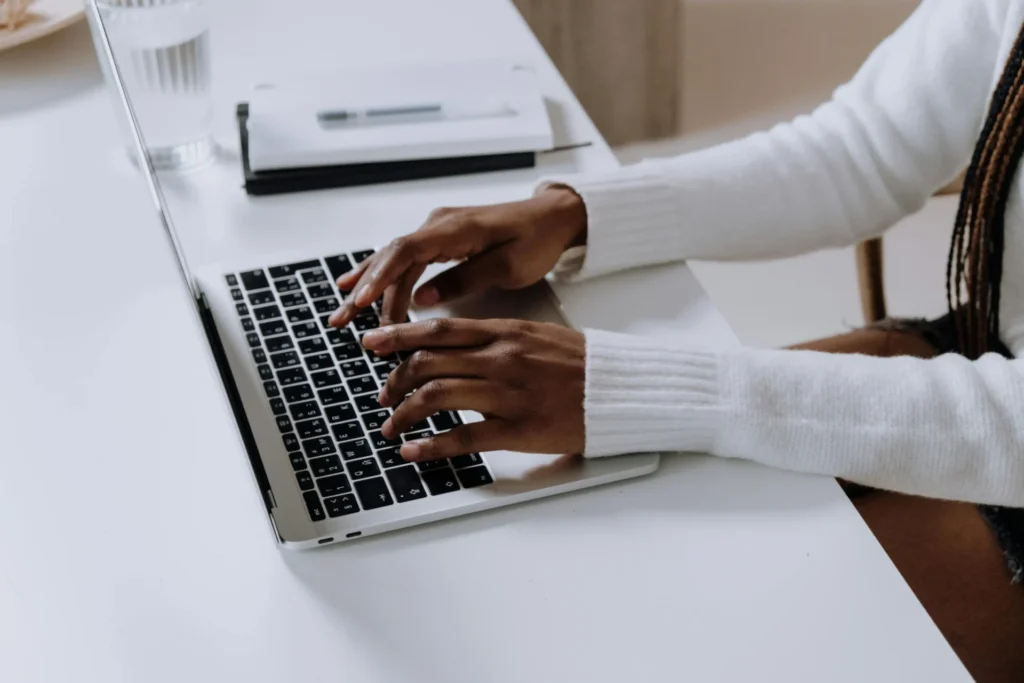 Professional working on a laptop at a minimalist desk while researching best alternative search engines for improved online discovery