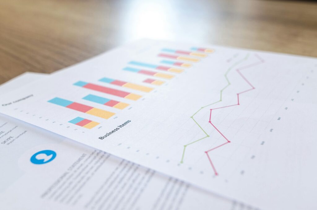 Printed business documents showing bar charts and line graphs, representing the analytics of an internal search engine for website usage.