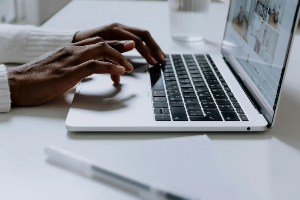 Workspace showing a laptop and notebook used to learn how to optimize for AI answers.
