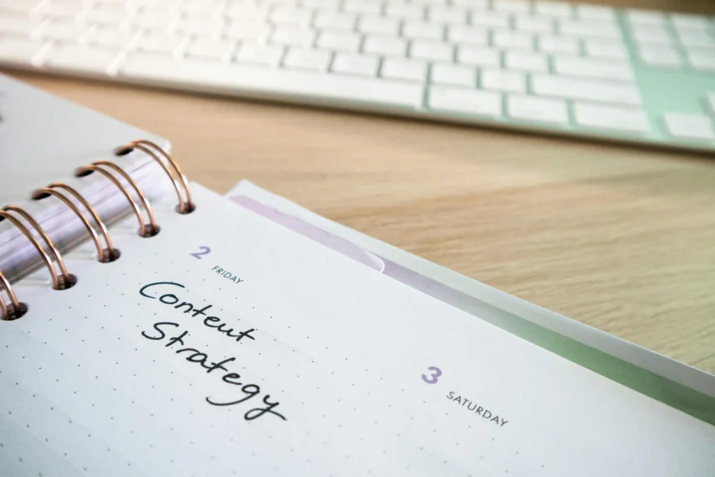 GEO content strategy planning written in a notebook with keyboard workspace setup.