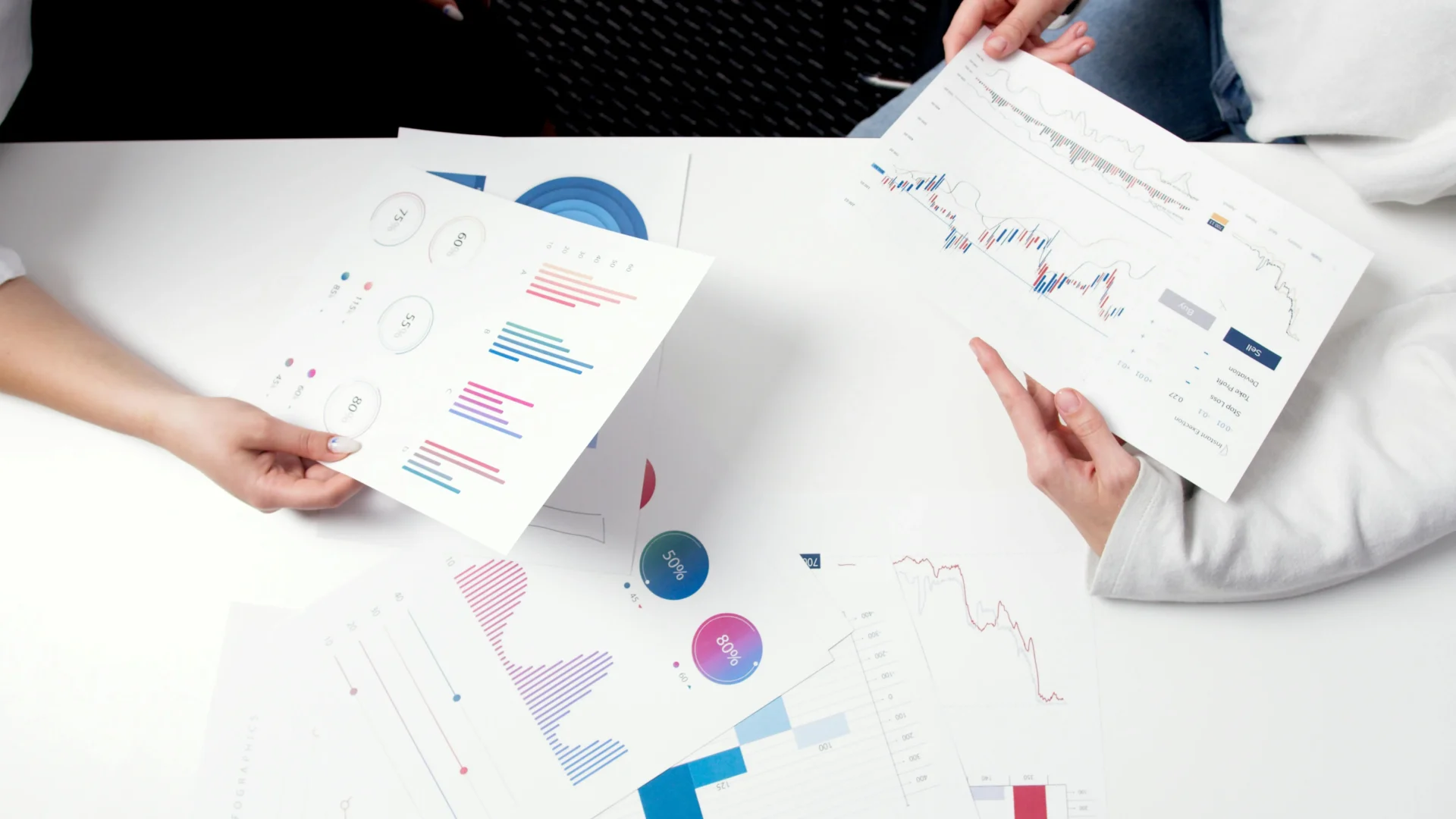 Two professionals reviewing data charts and analytics reports using techniques for boosting visibility in AI search algorithms.