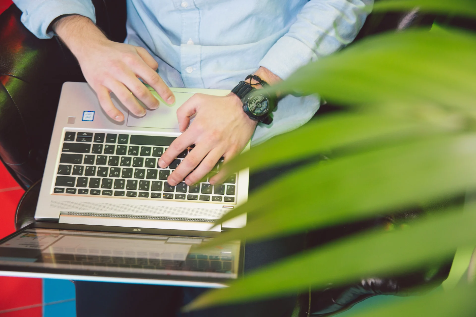 Professional typing AI search optimization prompts on a laptop in a modern workspace.