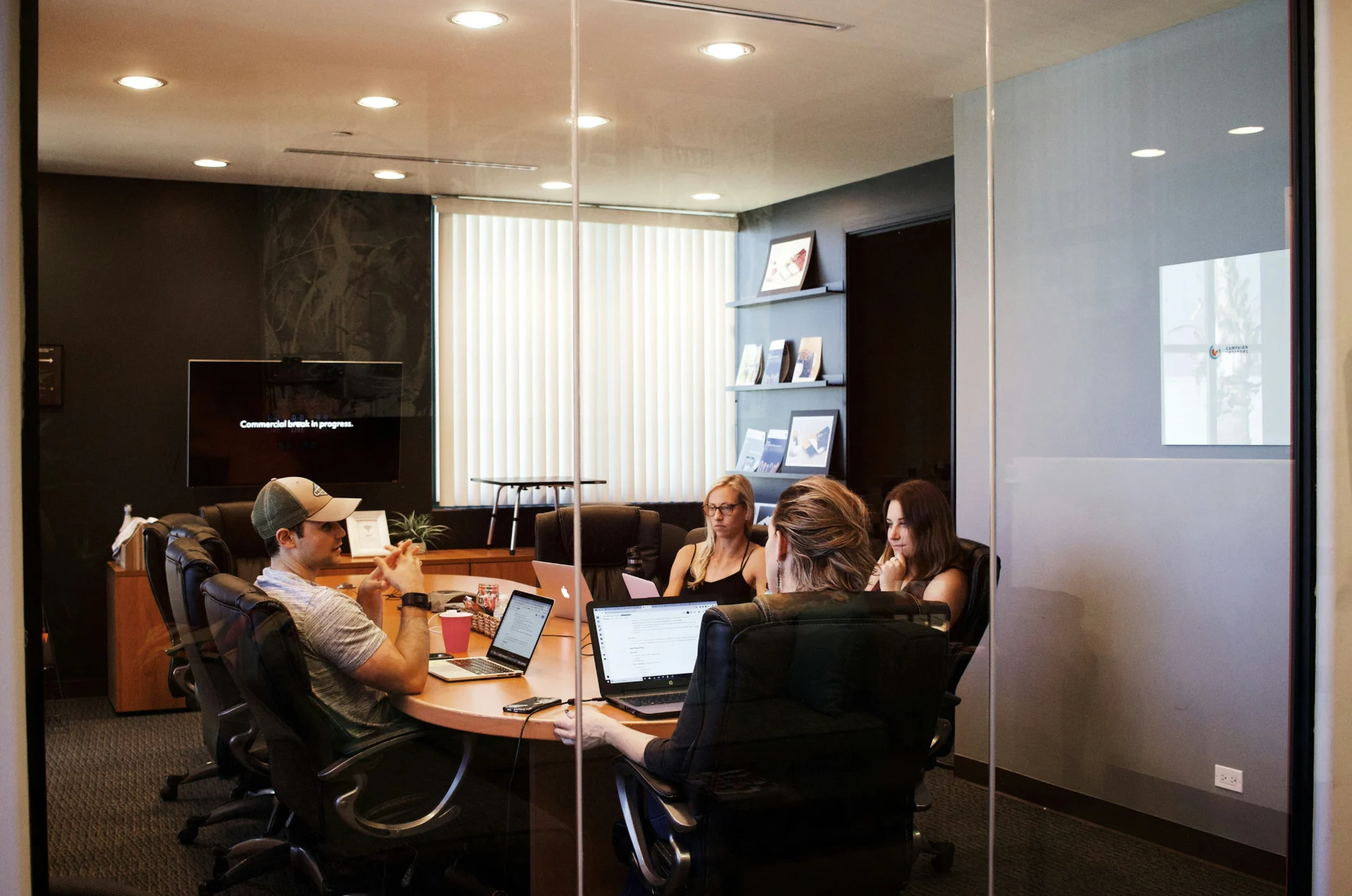 Marketing team collaborating in a conference room, discussing how to build AI trust signals for brands.