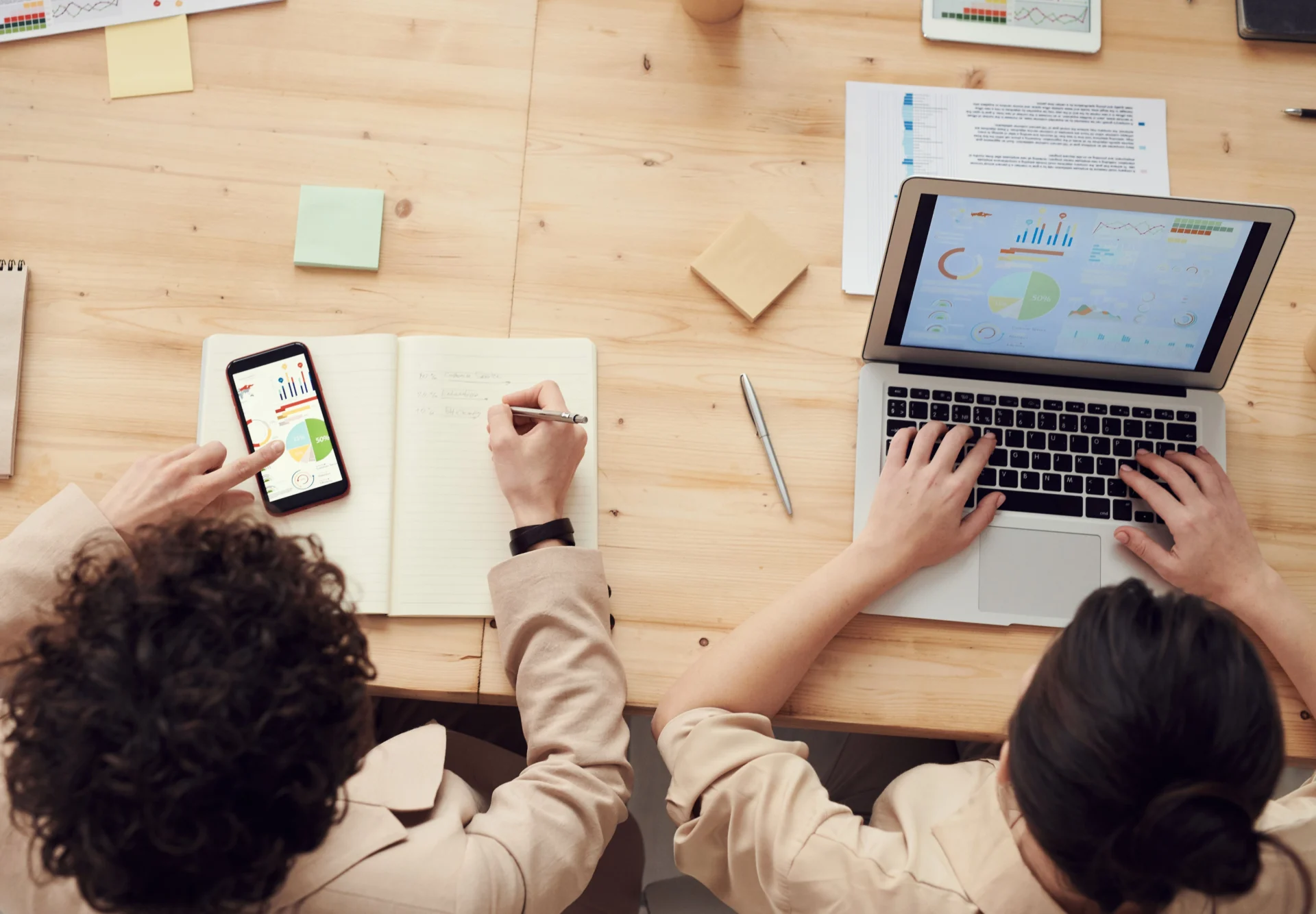 Marketers reviewing performance dashboards across devices using a GEO audit tool for website content.