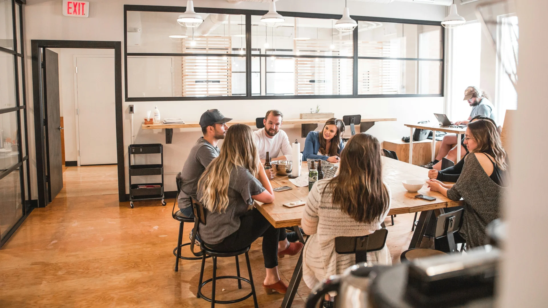 Marketing team discussing strategy in an open workspace, focused on GEO optimization for local search.