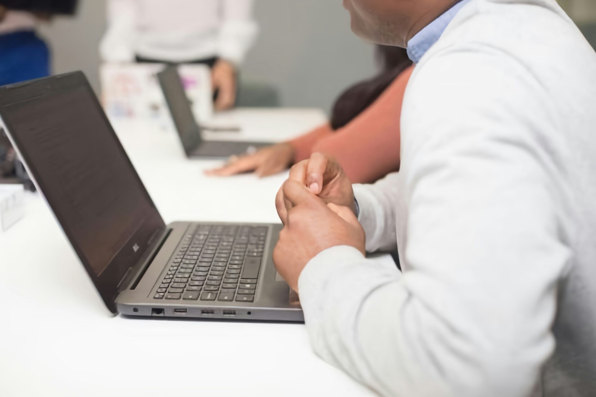Business professionals collaborating on laptops during a strategy meeting with best GEO agency for healthcare