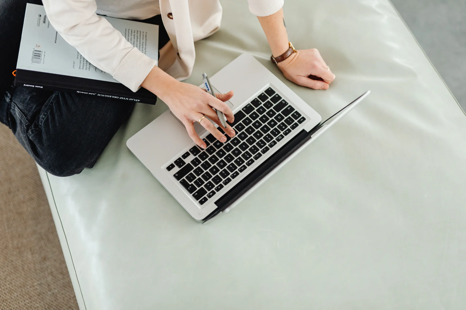 Hands typing on a laptop keyboard while drafting a press release for AI search distribution